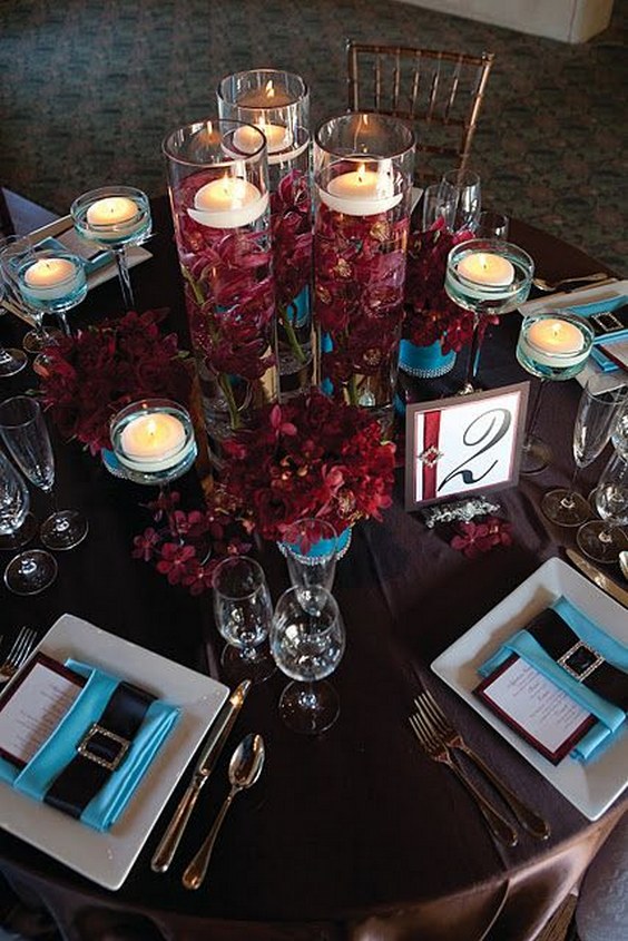 submerged burgundy orchids with floating candles wedding centerpiece